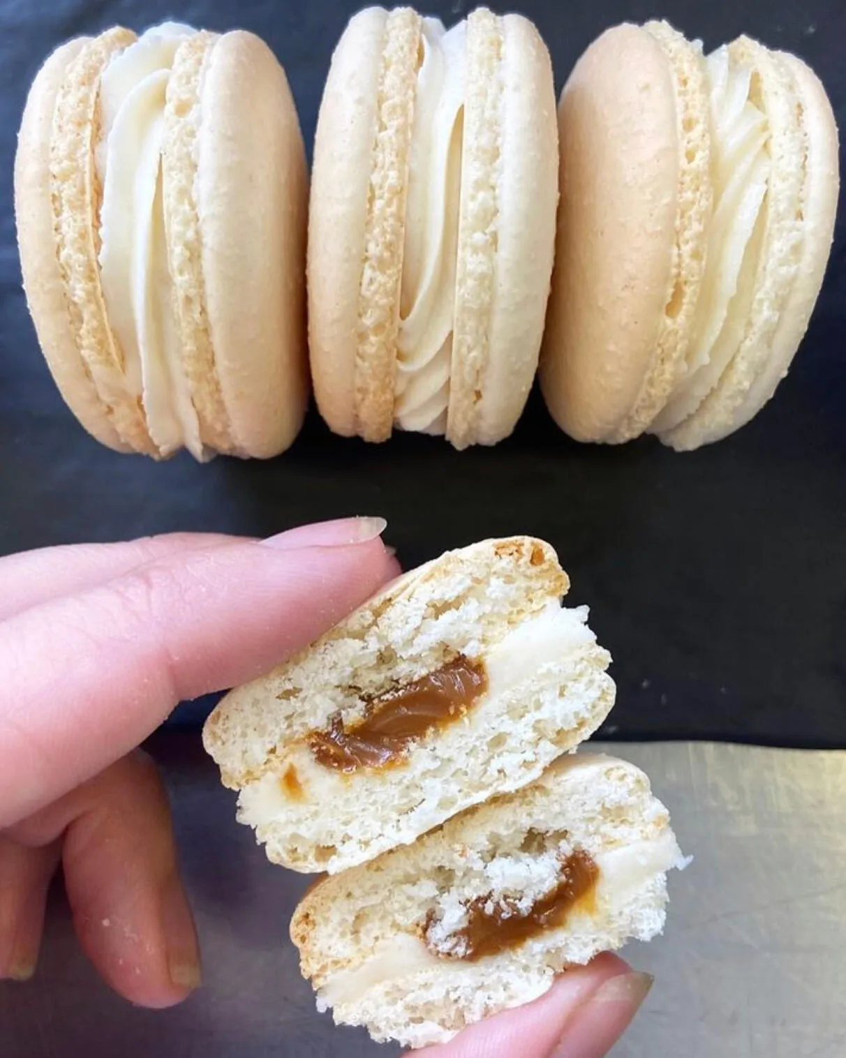 Macarons with one broken open to show a caramel center